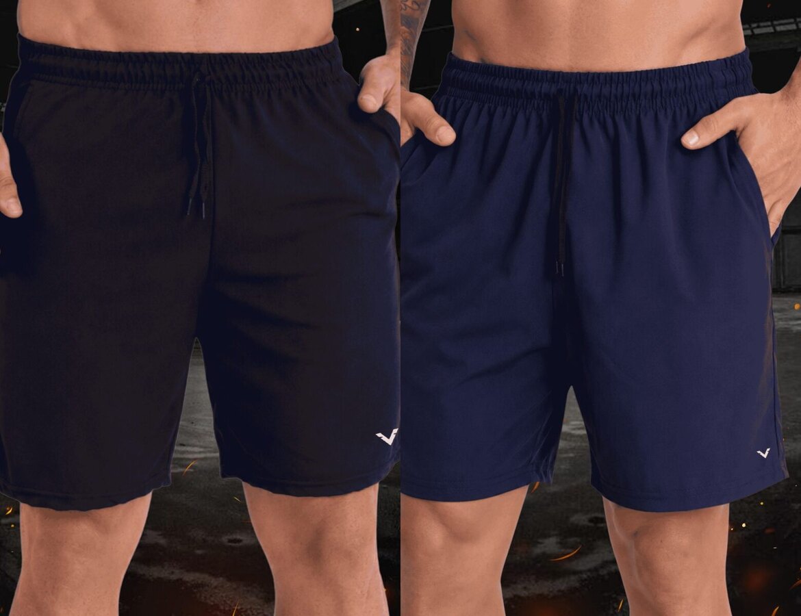 Dois shorts de tactel Vankoff, um preto e um marinho, vestidos por modelos, com brasas ao fundo.