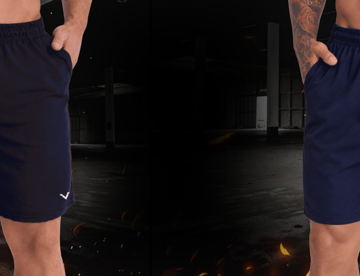 Dois shorts de tactel Vankoff, um preto e um marinho, vestidos por modelos, com brasas ao fundo.